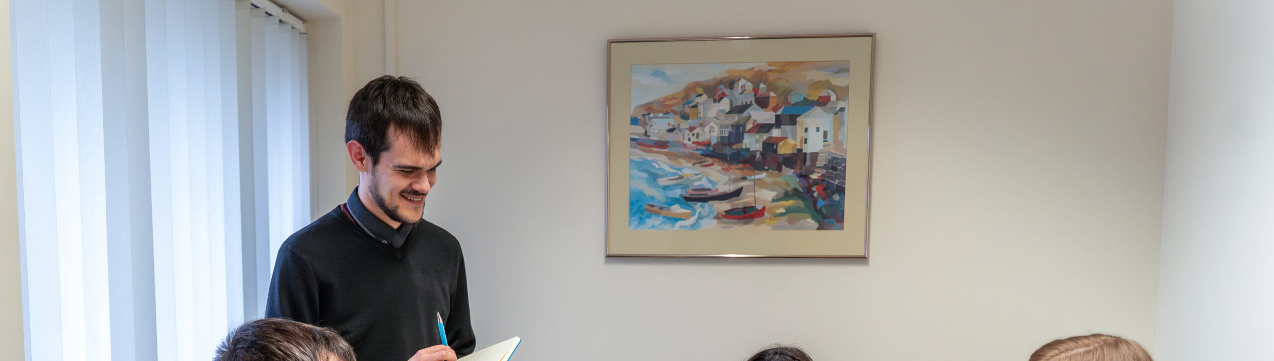 A solicitor discussing legal matters with clients in a meeting room at Ellis-Fermor & Negus, showcasing a professional and approachable environment.
