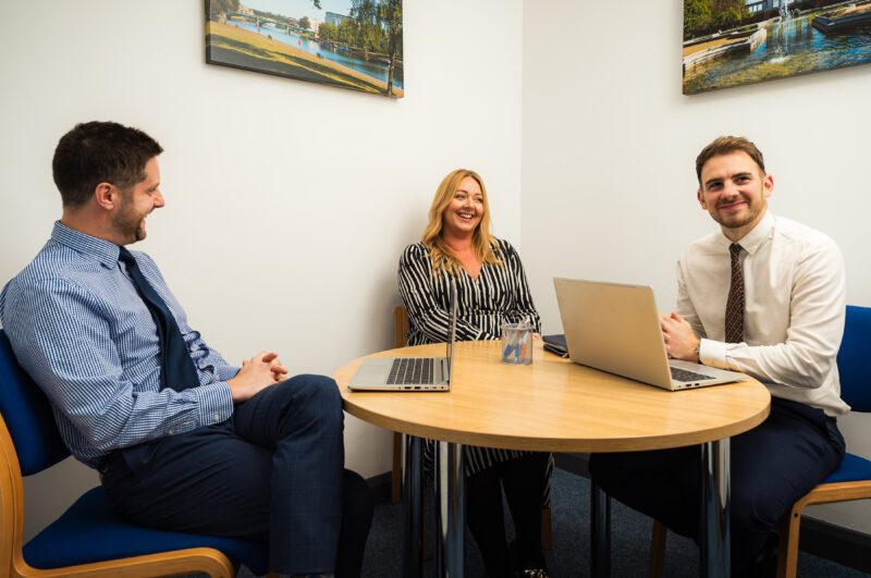 Three solicitors collaborating in an office setting at Ellis-Fermor & Negus, showcasing approachable legal advice in the East Midlands.