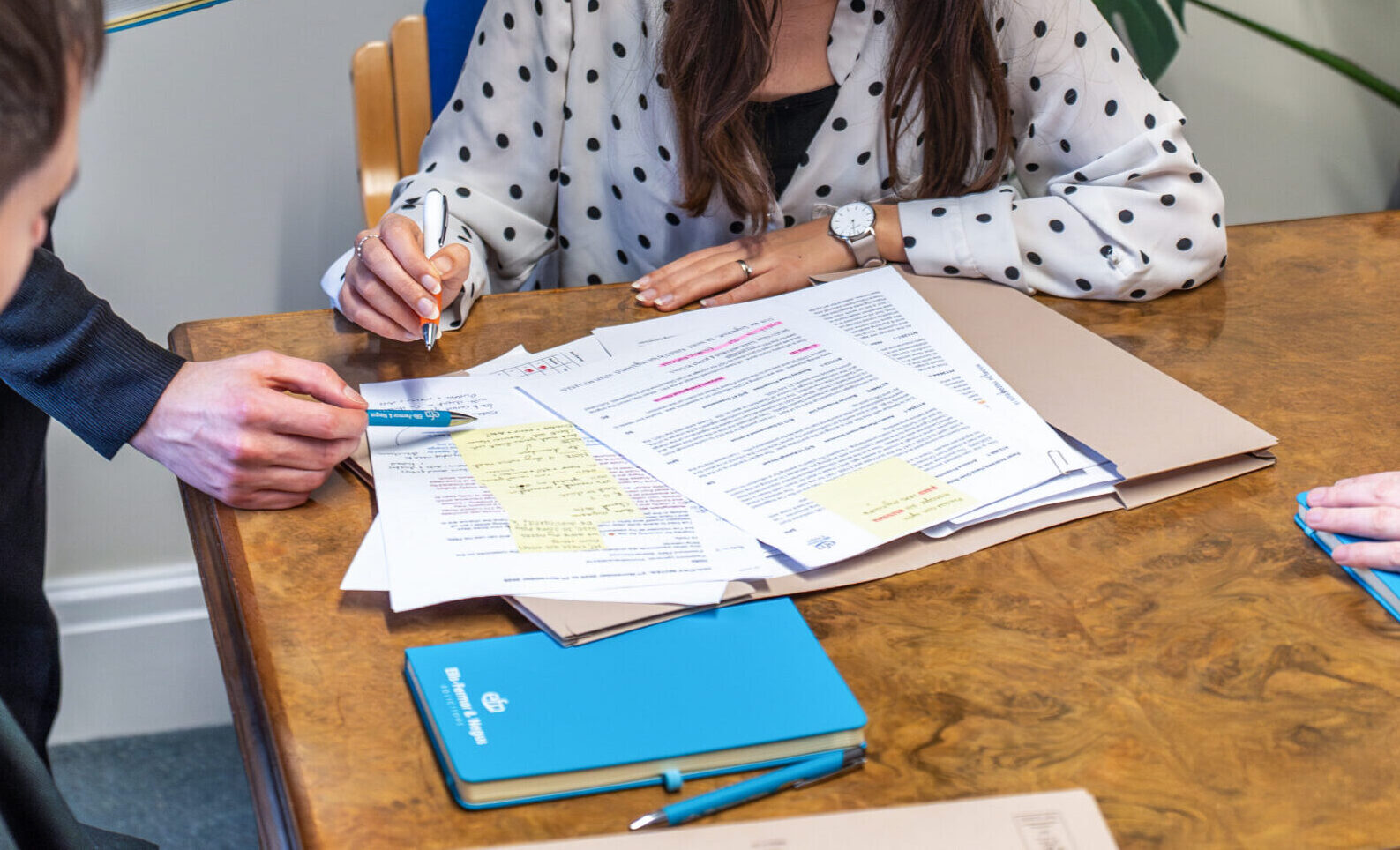 A legal consultation session featuring documents related to family law, residential conveyancing, and wills at Ellis-Fermor & Negus solicitors' office.