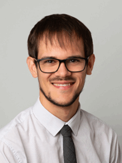 man with glasses wearing a shirt and tie