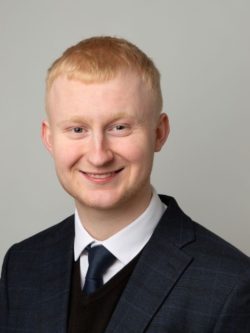 Man in smart dark suit with tie