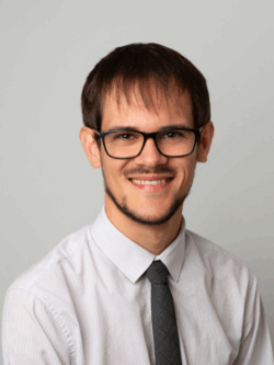 man in glasses wearing shirt and tie