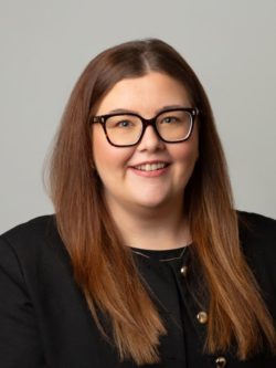 Women with glasses wearing black smart clothing