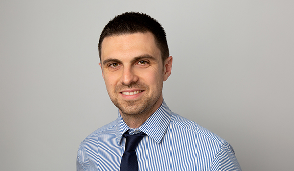 Man wearing a blue shirt and navy tie
