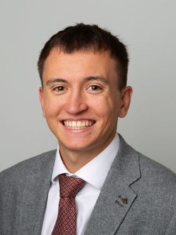 Man wearing a grey suit an red tie