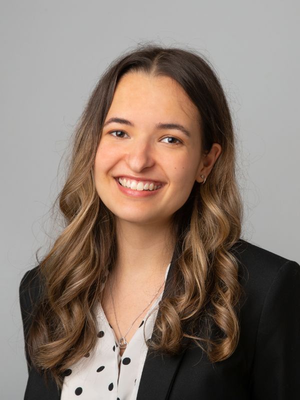 Portrait of a smiling solicitor with curly hair in a black blazer and polka dot blouse, representing Ellis-Fermor & Negus in the East Midlands