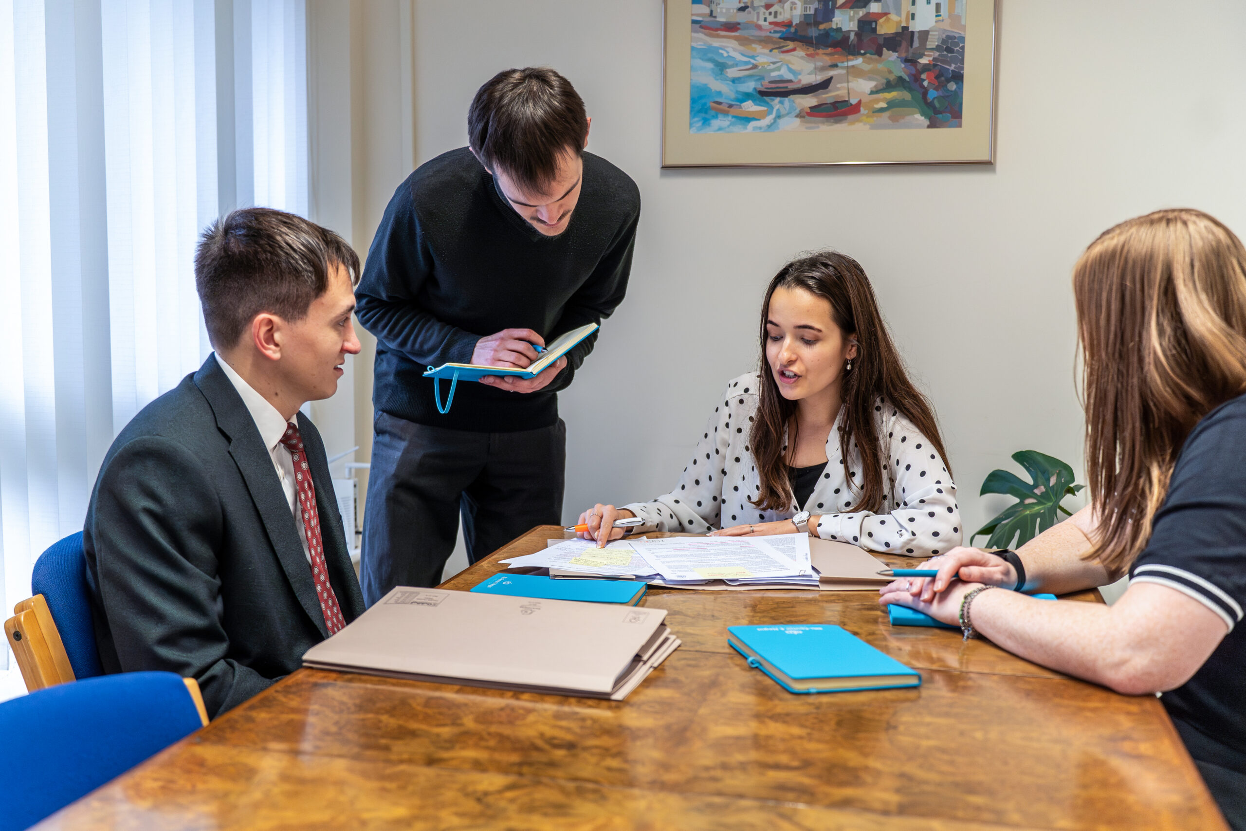 A group of solicitors discussing legal documents and providing advice at Ellis-Fermor & Negus, a solicitors' firm in the East Midlands.