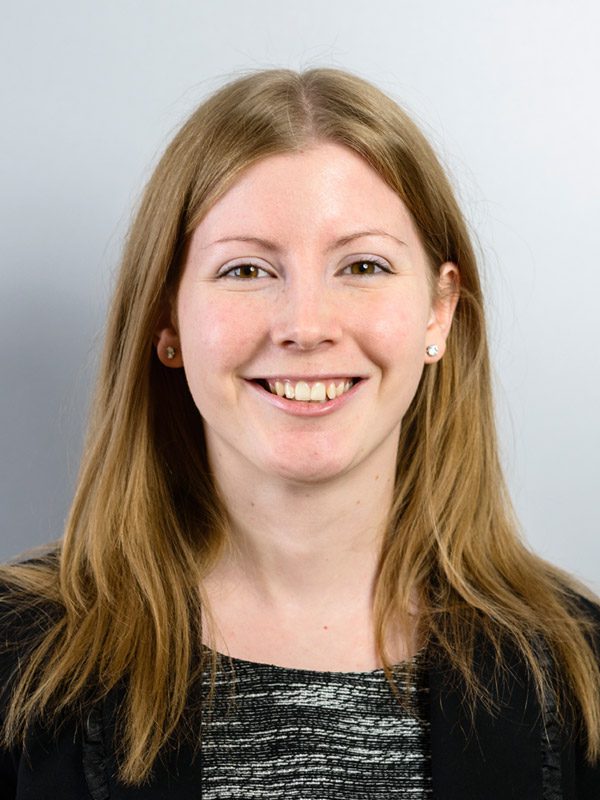 Smiling solicitor with long hair wearing a black jacket, representing Ellis-Fermor & Negus in the East Midlands.