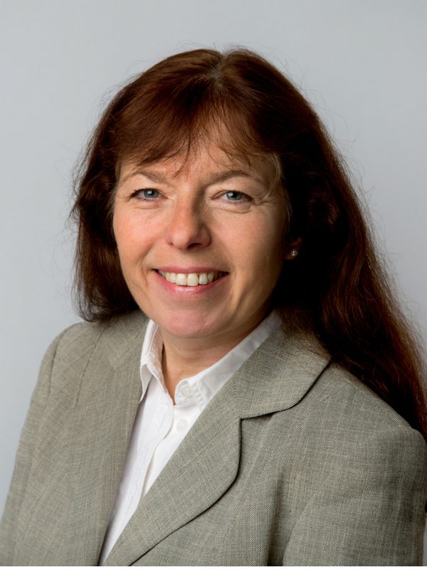 Smiling female solicitor in a grey blazer, representing East Midlands solicitors firm, Ellis-Fermor & Negus, offering legal advice.