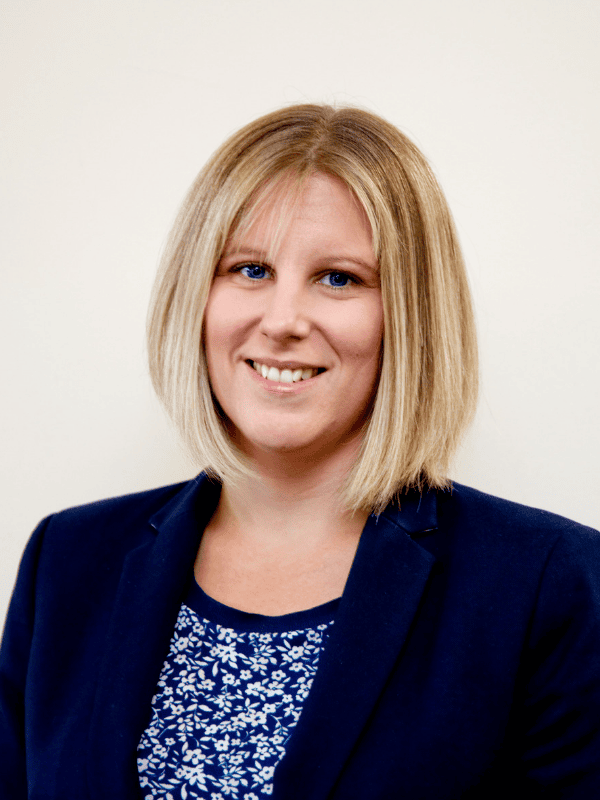 Smiling solicitor from Ellis-Fermor & Negus wearing a blue blazer against a neutral background