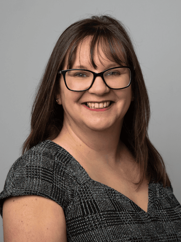 Headshot of a smiling solicitor wearing glasses, representing Ellis-Fermor & Negus, a solicitors firm in the East Midlands.