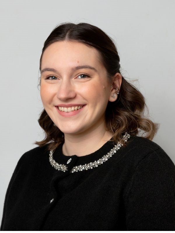 Smiling young female solicitor from Ellis-Fermor & Negus, providing approachable legal advice.