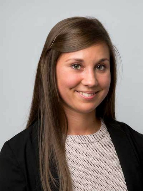 Smiling female solicitor from Ellis-Fermor & Negus in a business attire, offering approachable legal services in the East Midlands.