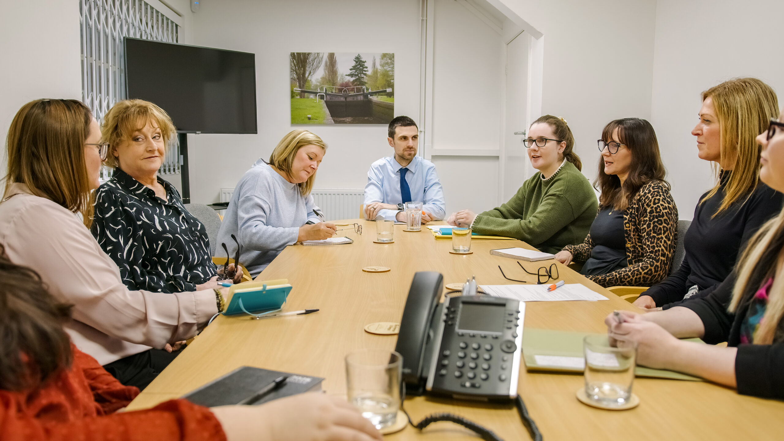 A group of solicitors discussing legal matters during a team meeting at Ellis-Fermor & Negus, showcasing collaboration and professional engagement.