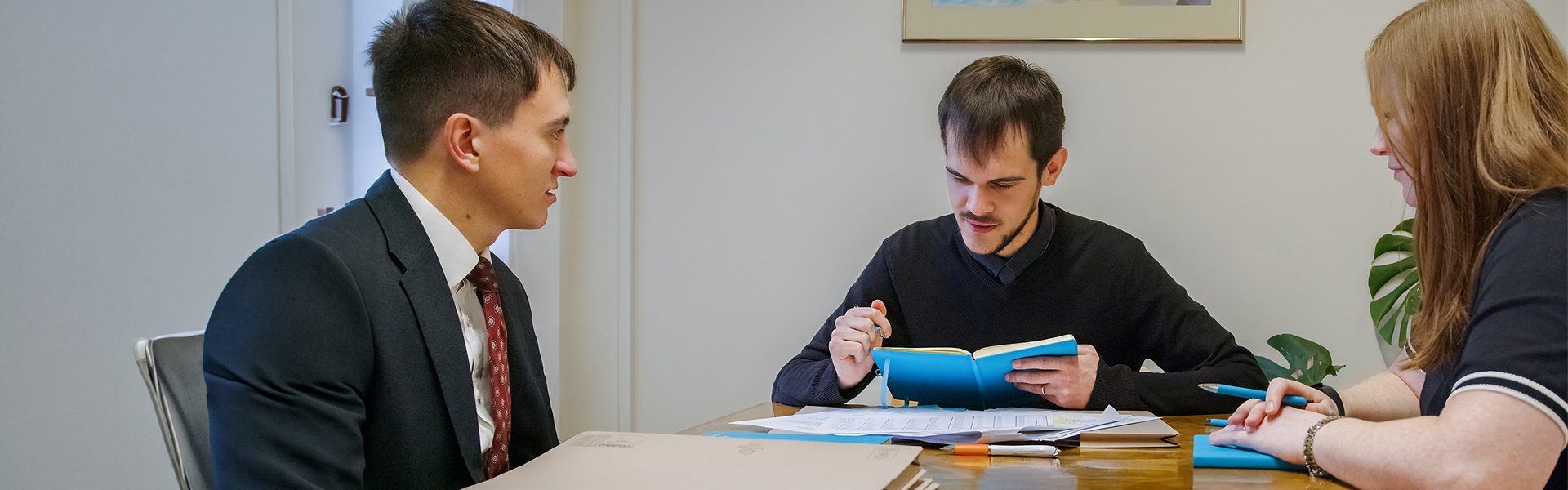 Two solicitors discussing legal documents during a consultation at Ellis-Fermor & Negus, an East Midlands solicitors' firm.
