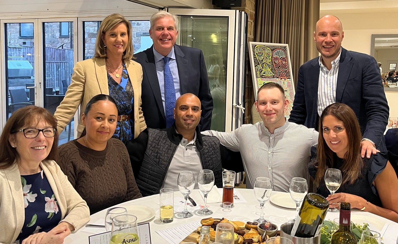 Group of professionals enjoying a dinner celebration, highlighting teamwork and camaraderie at Ellis-Fermor & Negus solicitors in the East Midlands.
