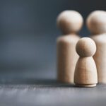 Three wooden figurines representing family dynamics, relevant to legal services such as family law and divorce provided by East Midlands solicitors.